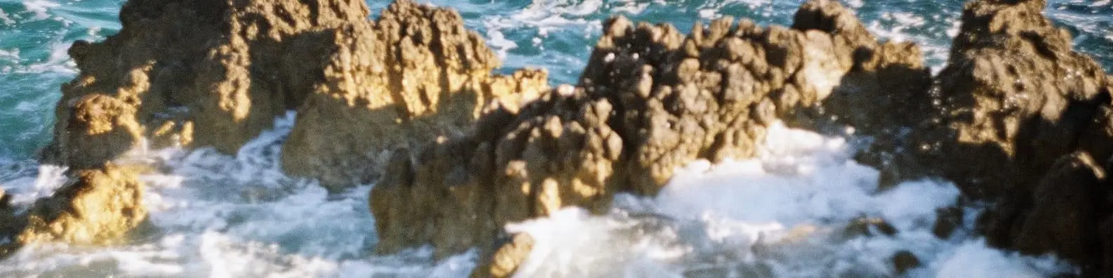Waves Crashing Over Rugged Rocks