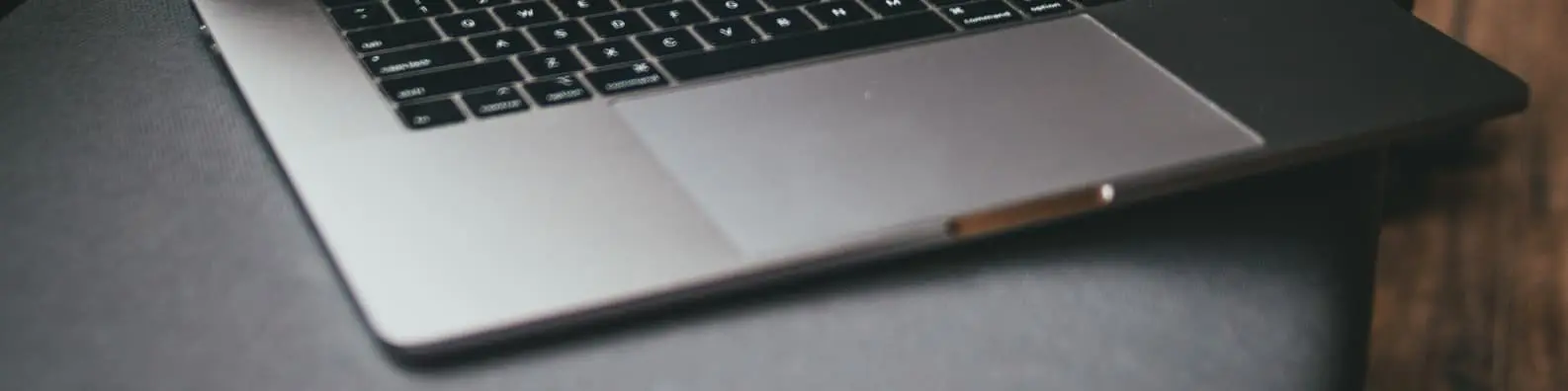 Work Essentials – Laptop Keyboard on Black Desk